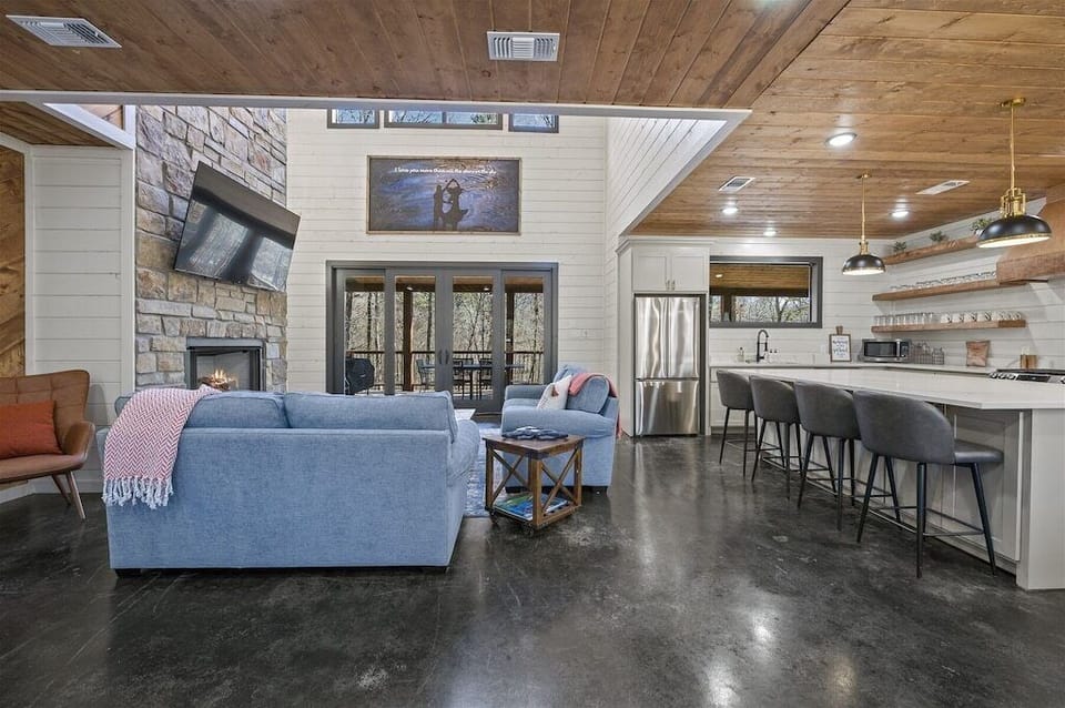 Living Room: Relax by the fireplace and enjoy the scenic views through spacious glass doors!