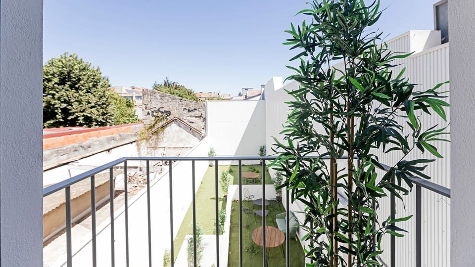 Step out onto your private balcony and breathe in the fresh air while enjoying the peaceful view of the urban landscape and a charming green space below. This serene outdoor retreat provides a perfect spot for morning coffee or an evening unwind amidst lu
