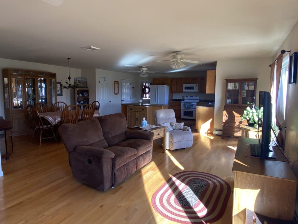Living room, dining room, kitchen from far corner.