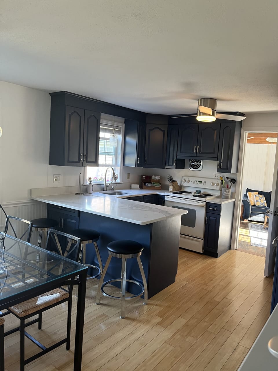 Breakfast bar with stools as well as a kitchen table 