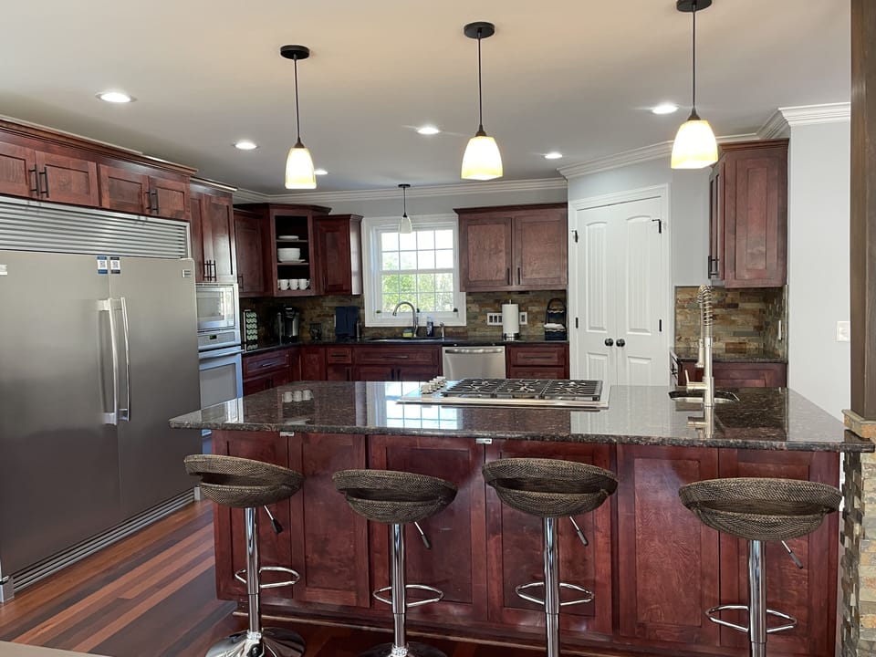 Adjustable height bar stools surrounding the kitchen island 