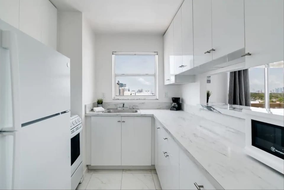 Efficiency meets style in this delightful kitchenette retreat.
