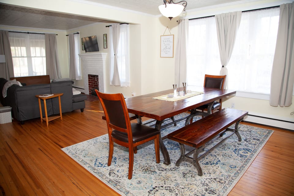 Plenty of natural light from the bay window; with seating for 8 at the table. 