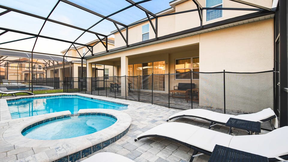 Inviting patio with private pool, spa, sun loungers, and covered seating area.
