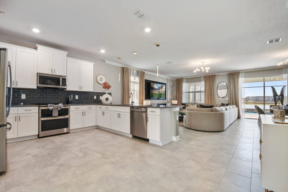 Spacious open-concept kitchen and living area with lake views and designer touches.