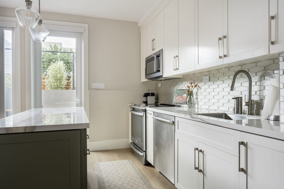 Fully-equipped kitchen with brand new stainless appliances - electric range, microwave, french door refrigerator w/ filtered water, dishwasher, drip & Nespresso coffee makers, toaster, pots + cooking staples (spices + oils, etc.)