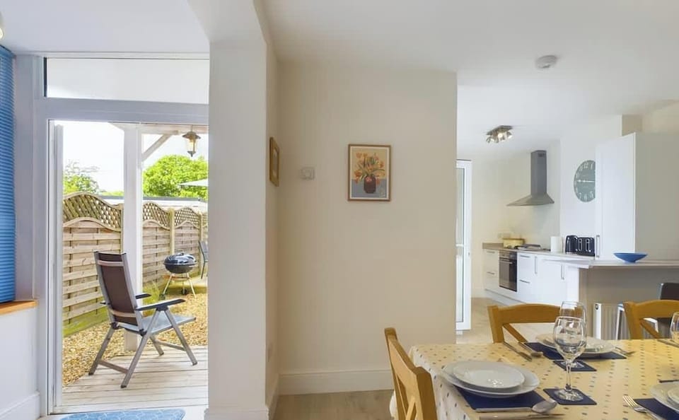 Modern kitchen and dining space at East View with appliances, worktops and family meal seating.
