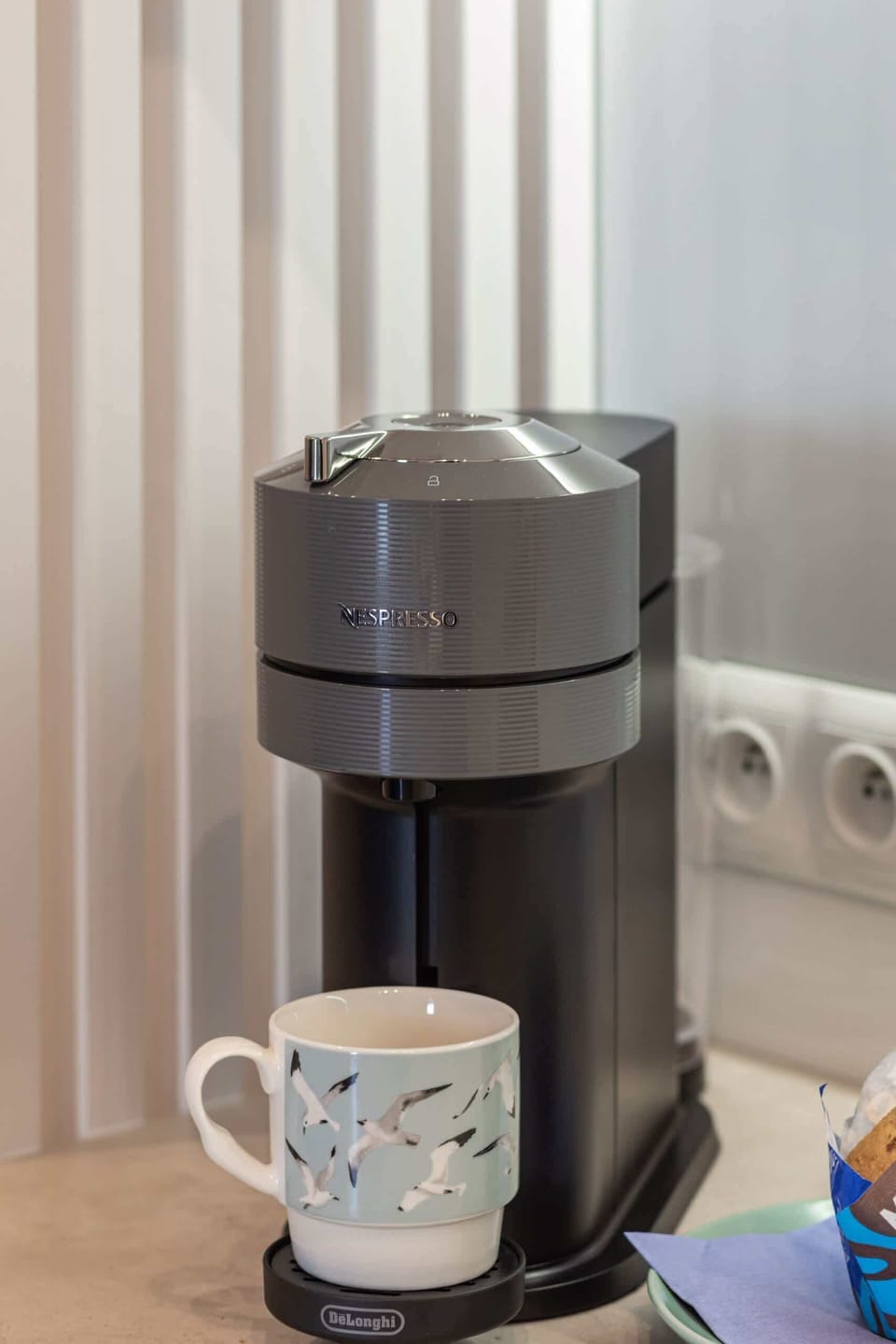 A close-up of a coffee maker with a mug, ready to prepare a fresh cup of coffee.
