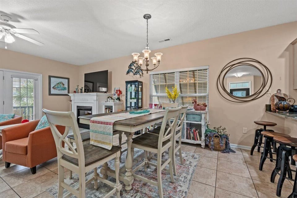 Gather around your elegant dining table, where warm lighting and cheerful decor create the perfect setting for memorable meals together.