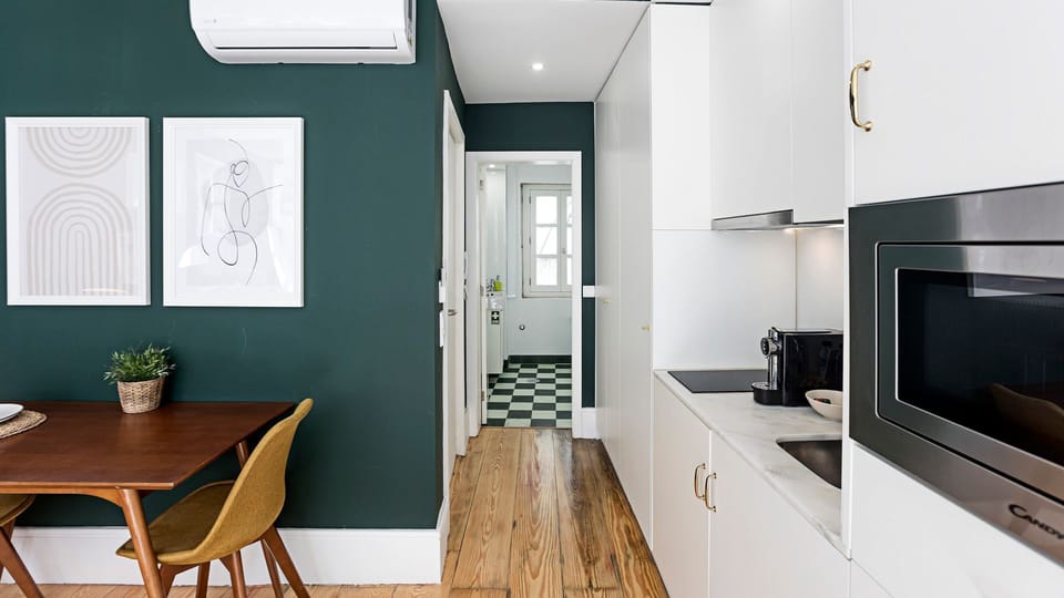 Discover the thoughtful design as you transition from the main living space towards the private bathroom, with charming checkered floors adding a touch of classic character. This hallway showcases the cohesive modern aesthetic, leading you to your refresh