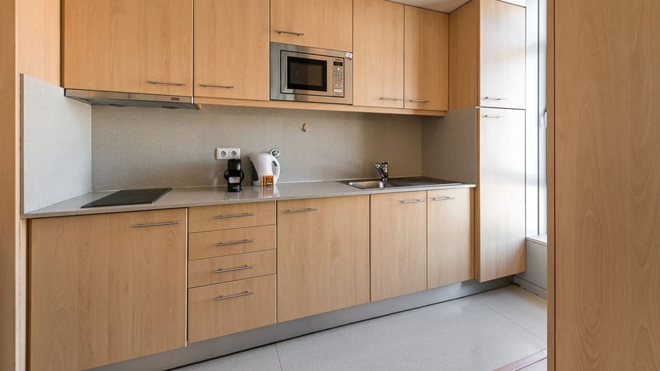Practical kitchenette, equipped with all the supplies you might need to cook your homemade meals #modern #lovelystay #airbnbporto