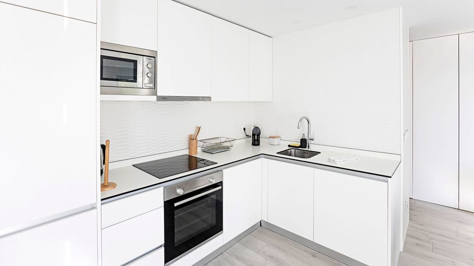 Modern kitchenette, equipped with all the supplies you might need during your stay, like an oven, stove, microwave, kitchen utensils, coffee machine, etc #practical #modern #nice