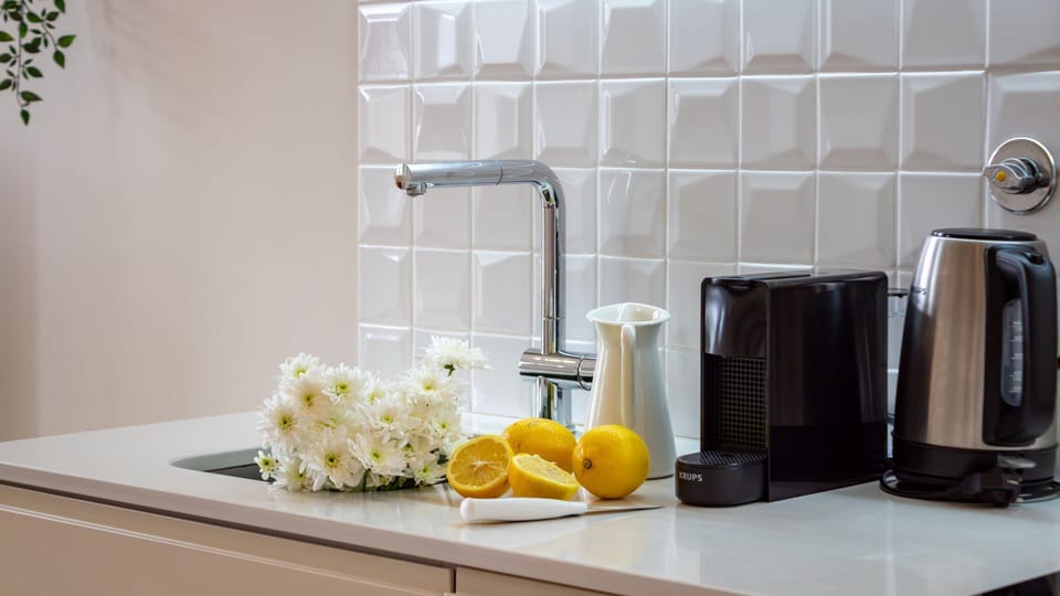 Prepare a refreshing cup of coffee or tea to start your day, making every morning feel like a special treat. The gleaming surfaces and thoughtful touches ensure a pleasant culinary experience.