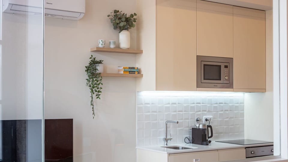 The sleek and functional kitchen area provides everything you need, from a convenient microwave for quick snacks to ample storage, ensuring a seamless and enjoyable culinary experience during your stay. #Kitchenette #ModernLiving #EfficientDesign #Cooking