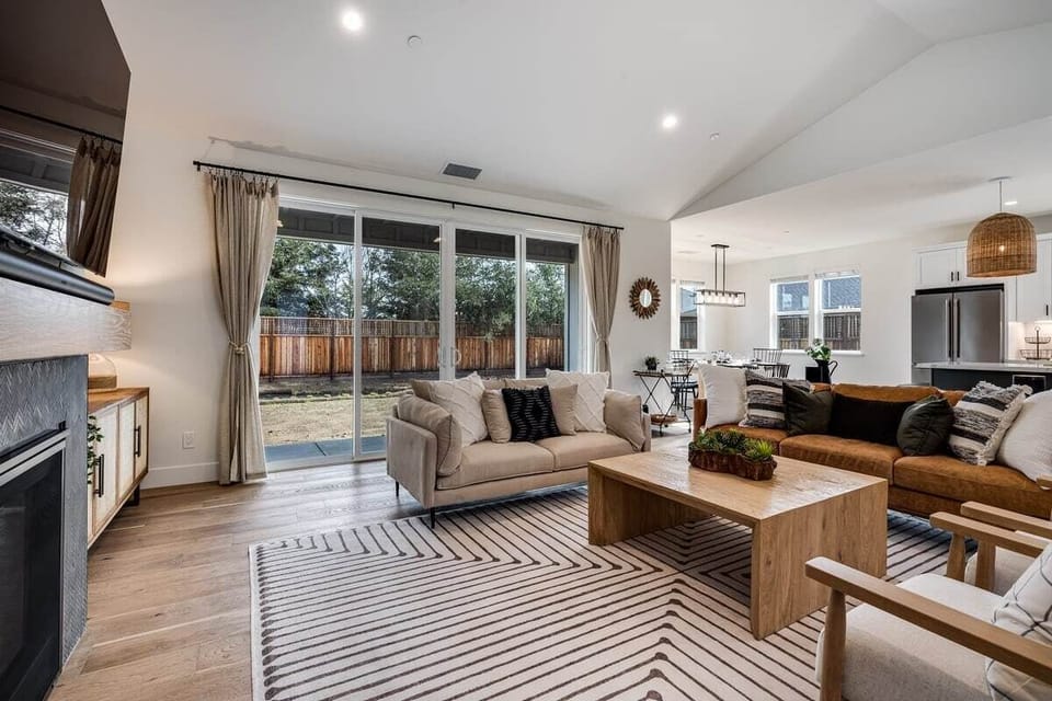 Living area with a 65 inch smart TV, SONOS surround sound system, gas fire place, board games. 