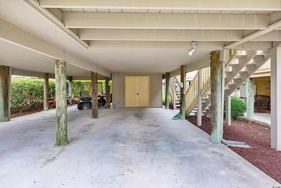 Parking for 2 cars, storage area with bch chairs & cooler. Outdoor shower & hose