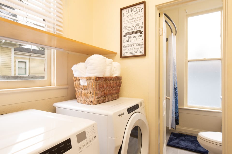 Modern Laundry equipment w/ plush towels.