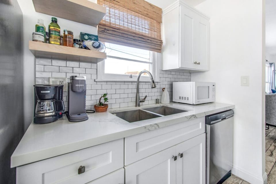 Kitchen with essentials: coffee maker, microwave, dishwasher, and more.