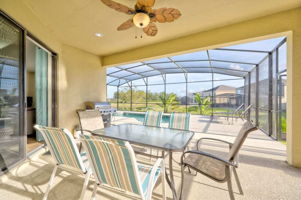 Outdoor covered lanai overlooking the pool with grill and outdoor TV.  There is a 2-piece bathroom off of the lanai.  The grill is to be used outside of the screen enclosure as per HOA requirements. 