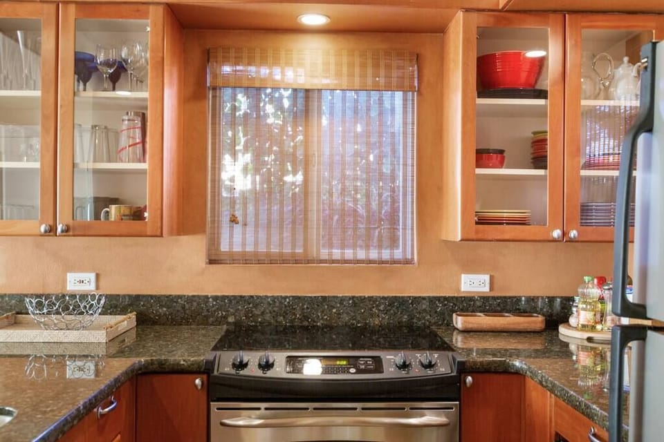 Fully stocked kitchen with pots and pans, dishes, bake wear and silverware.