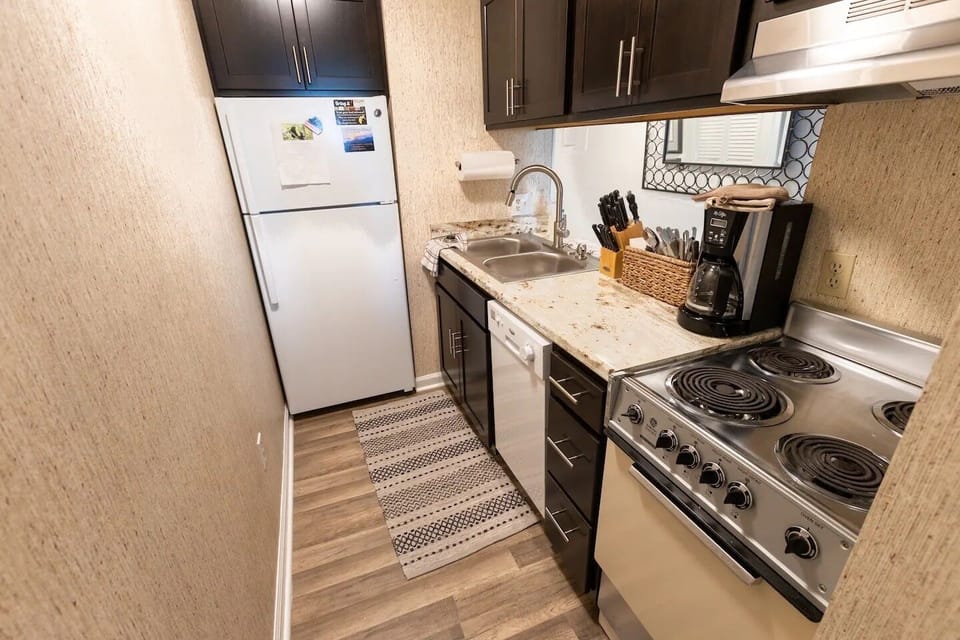 The kitchen has a full sized refrigerator, dishwasher, stove and oven. 