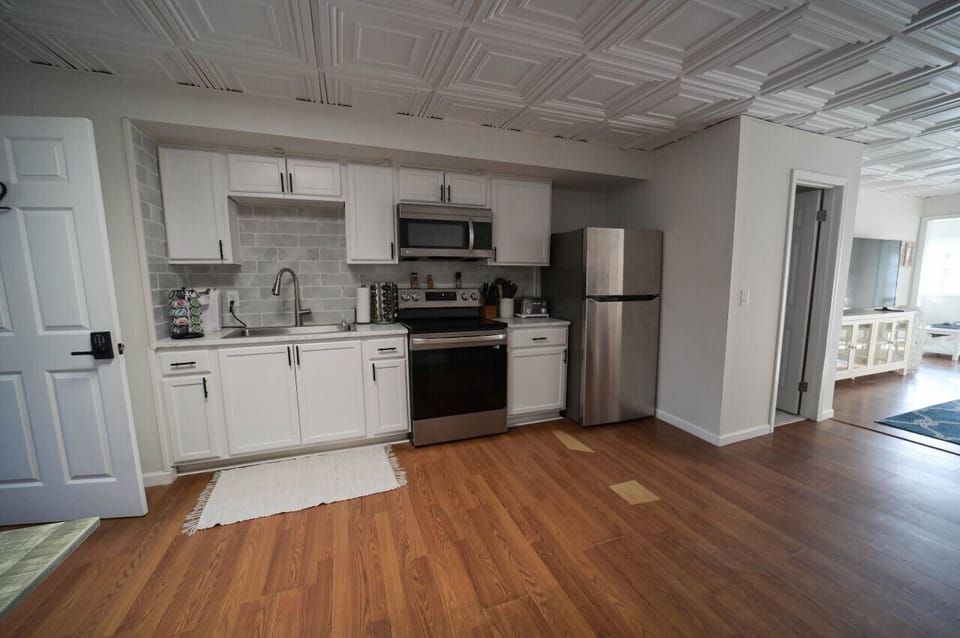 A bright and airy kitchen with a modern design and a touch of rustic charm. The perfect place to cook and create delicious meals.