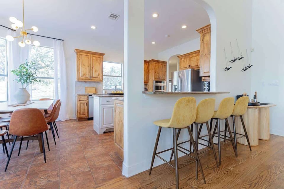 Four barstools are placed at the kitchen bar top.