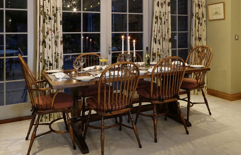 The dining table sits in the open plan kitchen and comfortably seats 6