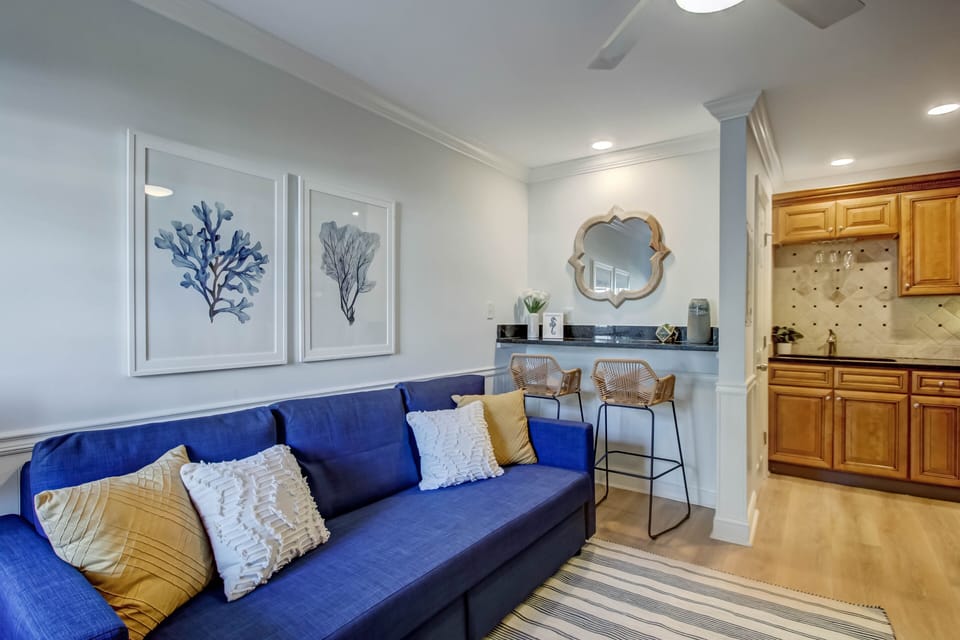 Downstairs features living room with sofa bed, flatscreen TV and full kitchen.