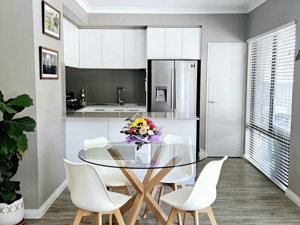 Naturally lit dining area with full size windows and well appointed kitchen.
