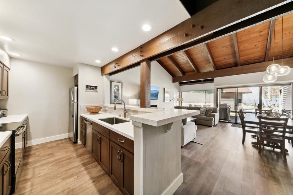Your spacious kitchen flows seamlessly into the living area, featuring granite counters and exposed beams for memorable meal prep.