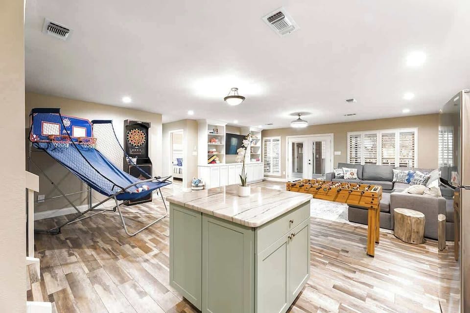 Downstairs recreation room with foosball, darts, basketball, bar area, and big screen tv!