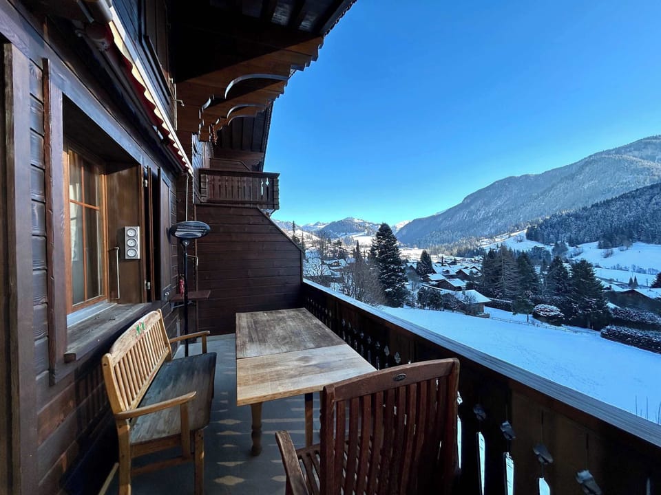 The sitting area on the balcony overlooks the snow-covered town.