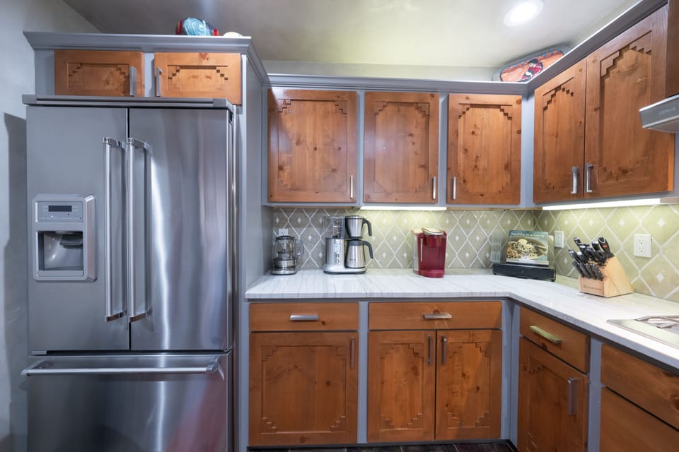 A kitchen with wood cabinets and stainless steel appliances.