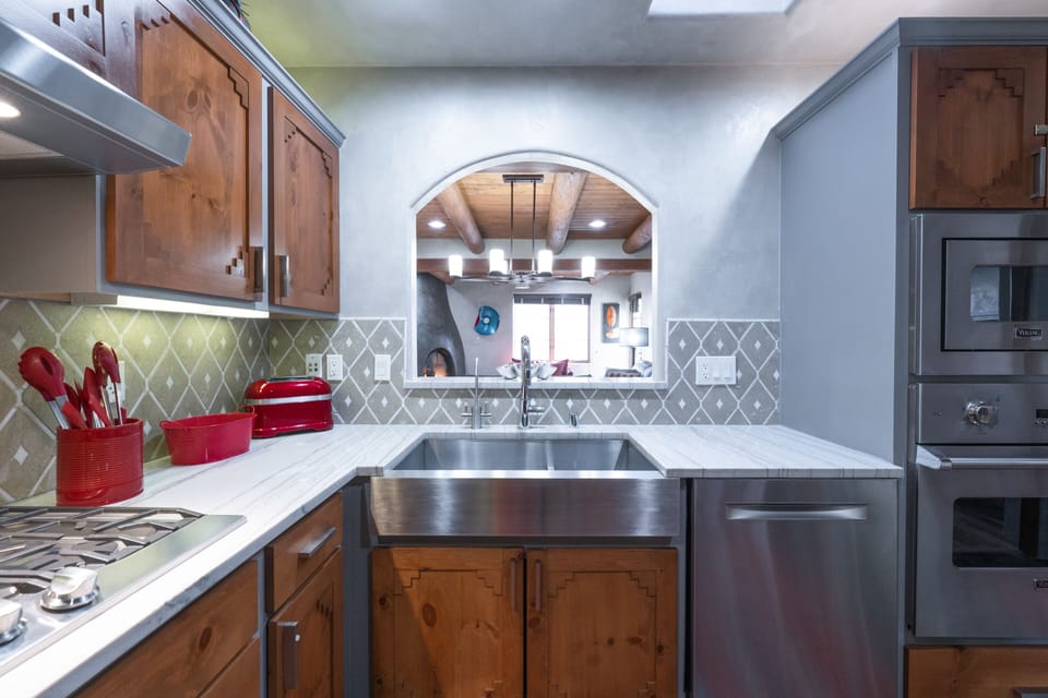 A kitchen with a stainless steel sink and stainless steel appliances.