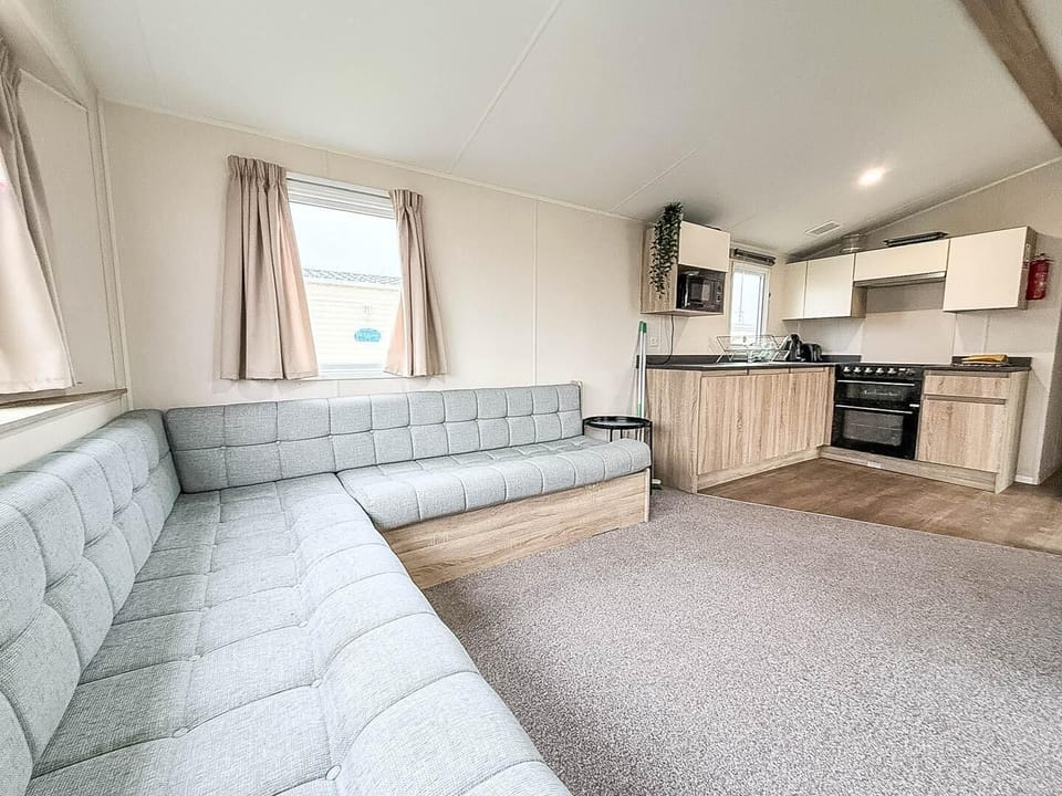 The caravan living room includes a fold-out bed, making it versatile for families.