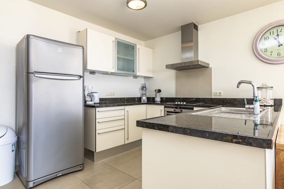 Fully equipped kitchen with oven, stove top, micro wave and refrigerator