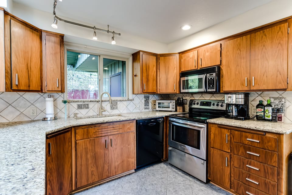 Full-Service Kitchen with Electric Range and Wall Oven. 