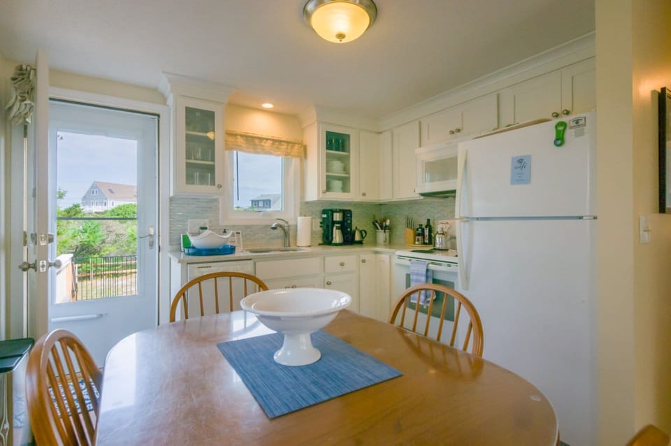 Dining table in kitchen with door to back deck
