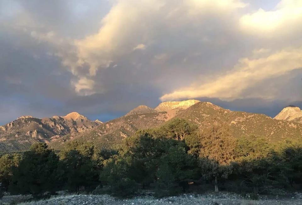 Majestic mountains kissed by sunlit clouds...