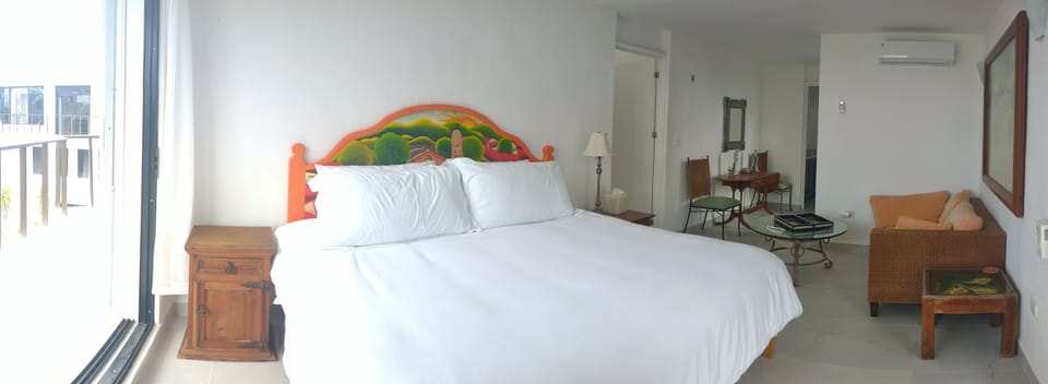 Master bedroom with ocean and jungle views from balcony, and en-suite bathroom.