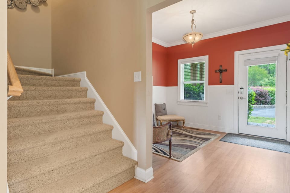 Stairway goes up to 4 bedrooms