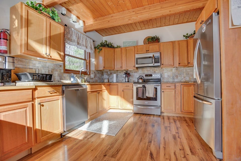 Kitchen supplied with necessary appliances such as, microwave, oven, dishwasher, fridge, stove, coffee maker, etc.
