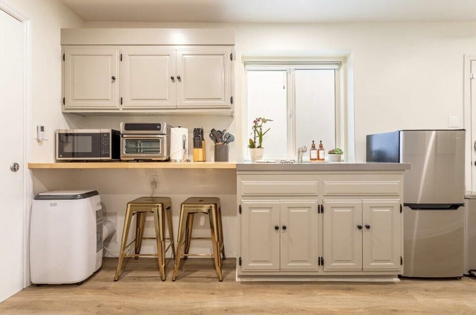 Whip up easy meals or your morning brew in this sleek kitchenette—equipped with everything you need for a breezy beachside stay.