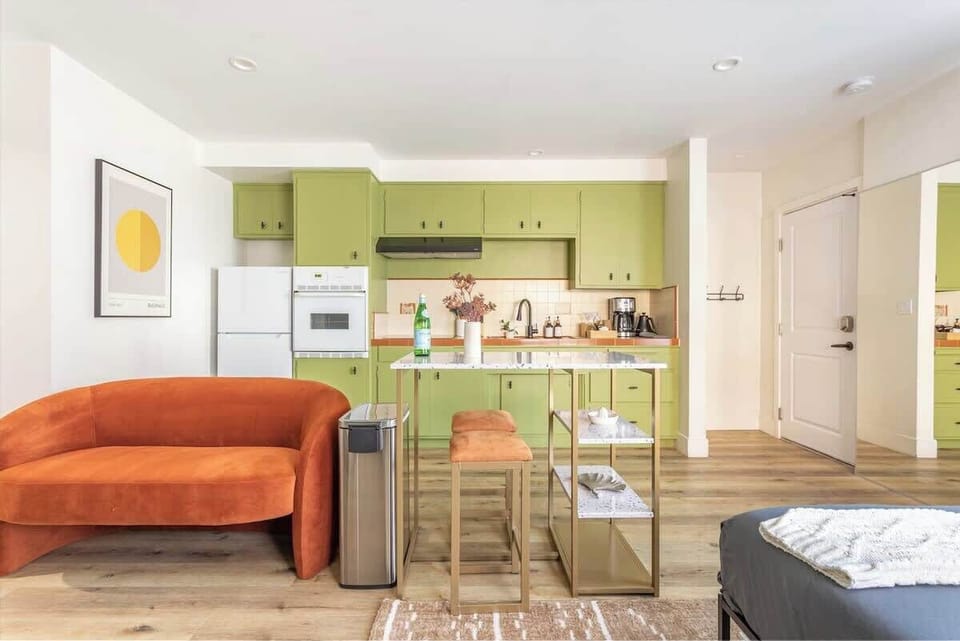 Stylish green cabinetry adds a cheerful pop of color to a space featuring a full range of modern appliances, including a refrigerator, and a coffee maker for your morning brew.

https://youtu.be/2QfoDzfnb3A