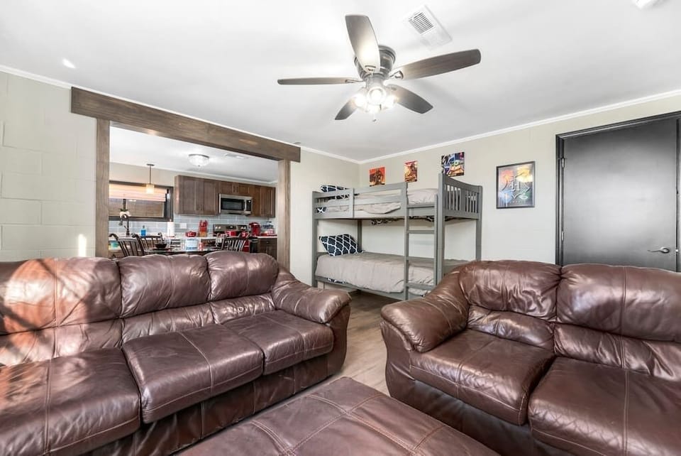 Living room includes twin bed bunk beds. 