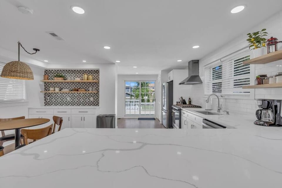 Gleaming quartz countertops and peninsula with bar seating for 4.