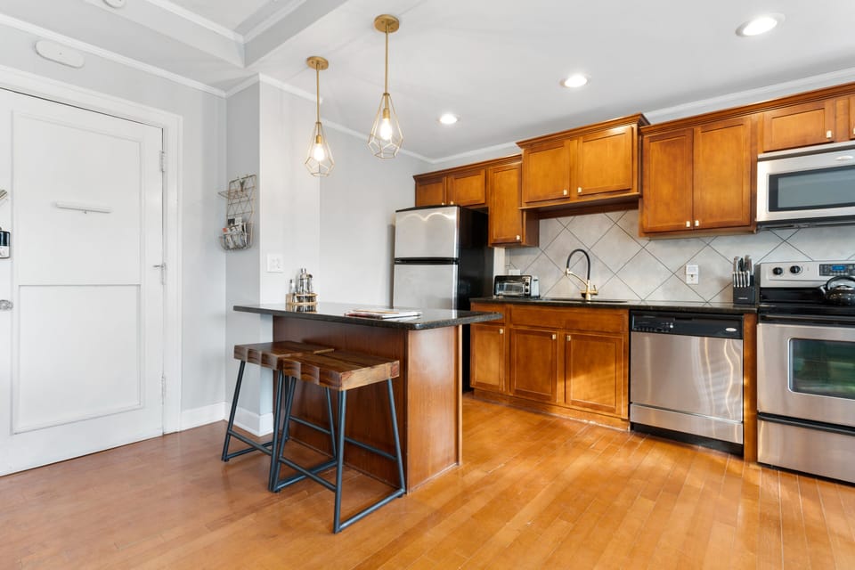 Open and airy kitchen design flows seamlessly into the living and dining areas, offering both style and functionality just steps from Kansas City’s streetcar and world-class attractions.