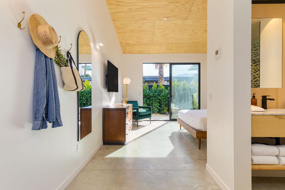 Unit A4 features a king bed, ensuite bathroom, private patio, and TV.