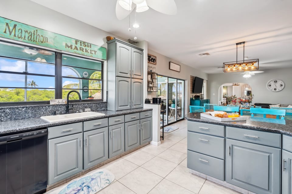 Modern kitchen with stainless steel appliances and granite countertops in Florida Keys rental.
